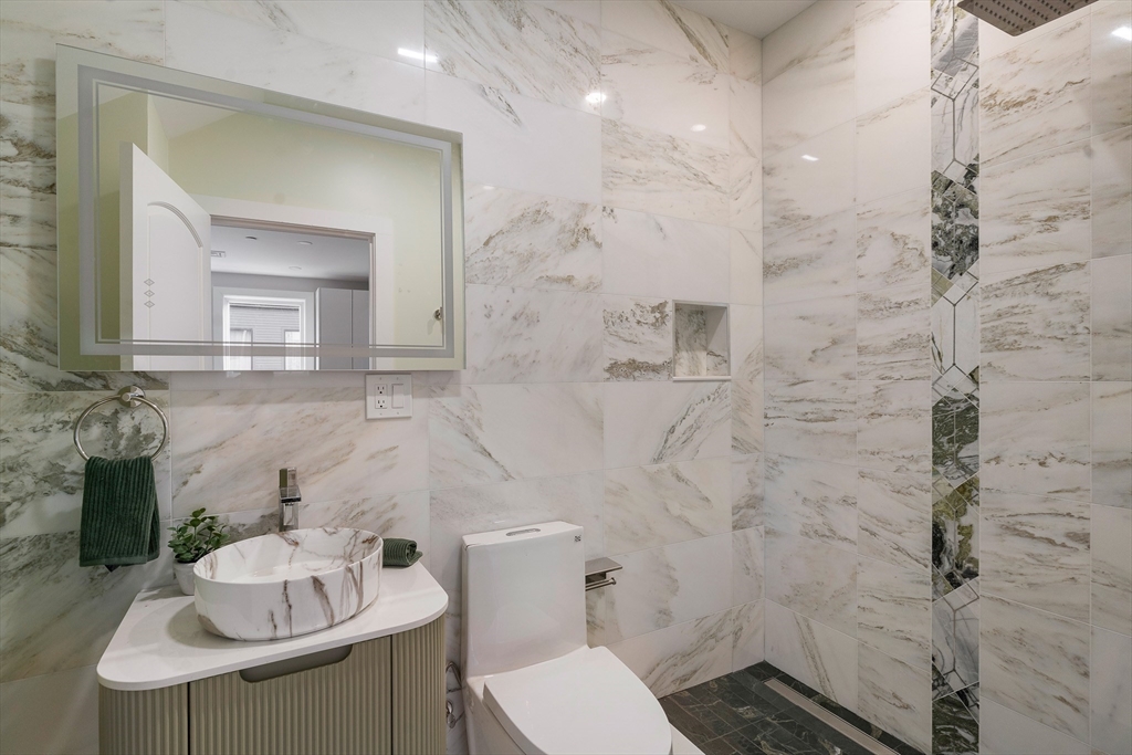 181 Maverick Street, Unit PH Boston, MA 02128 - Photo 17 of 20 a bathroom with a sink toilet and shower