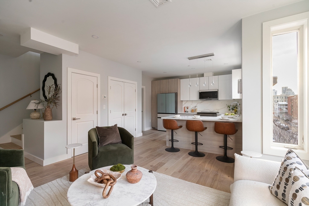 181 Maverick Street, Unit PH Boston, MA 02128 - Photo 4 of 20 a living room with furniture and a large window