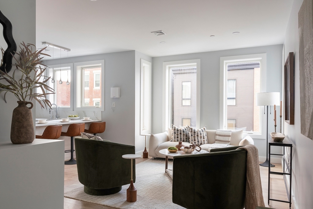 181 Maverick Street, Unit PH Boston, MA 02128 - Photo 6 of 20 a living room with furniture and a potted plant