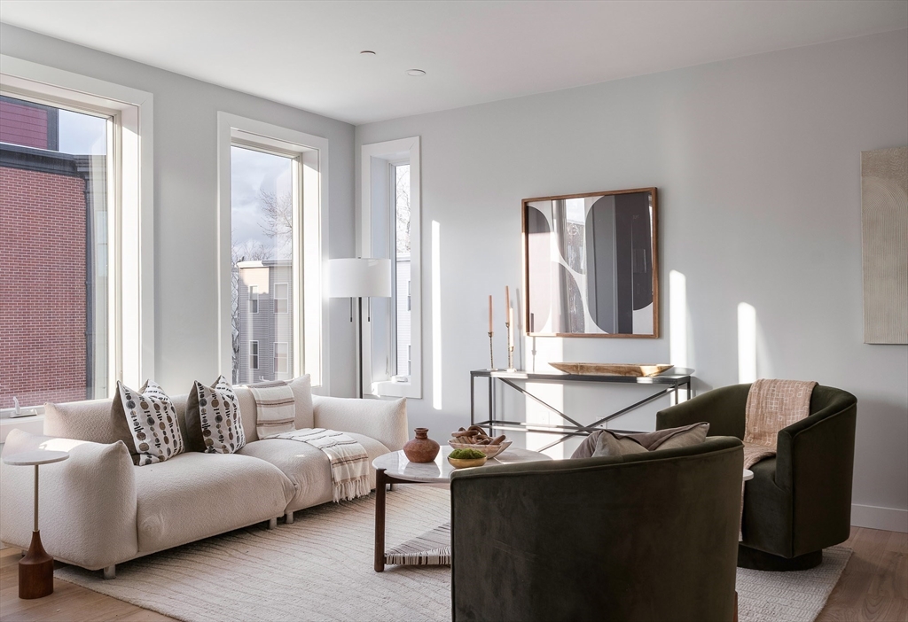 181 Maverick Street, Unit PH Boston, MA 02128 - Photo 7 of 20 a living room with furniture and large windows
