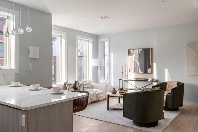 a living room with kitchen island furniture and a sink