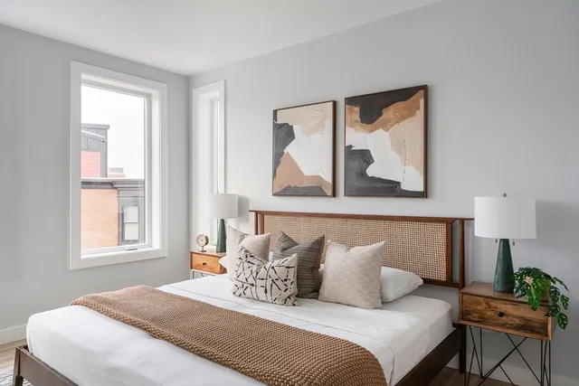 a bedroom with bed and night stand