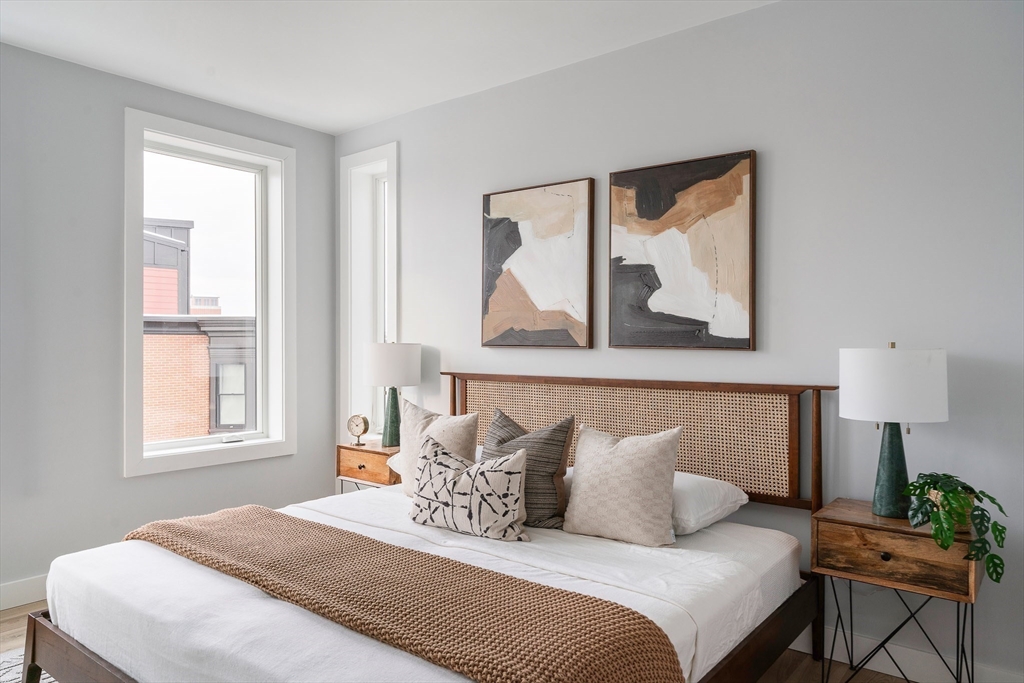181 Maverick Street, Unit PH Boston, MA 02128 - Photo 10 of 20 a bedroom with bed and night stand