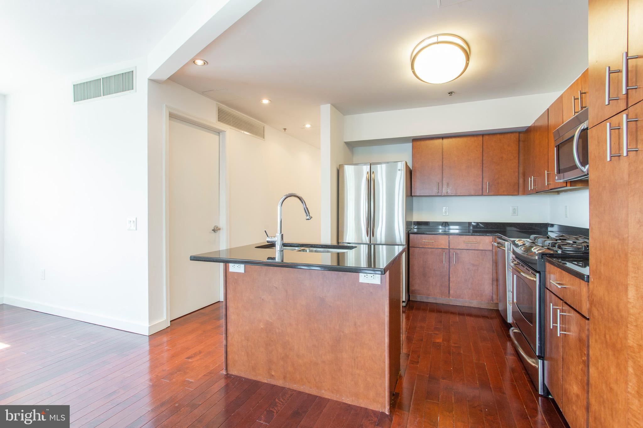 22 North Front Street, Unit PH1 Philadelphia, PA 19106 - Photo 12 of 42 a kitchen with stainless steel appliances granite countertop a stove a sink and a refrigerator