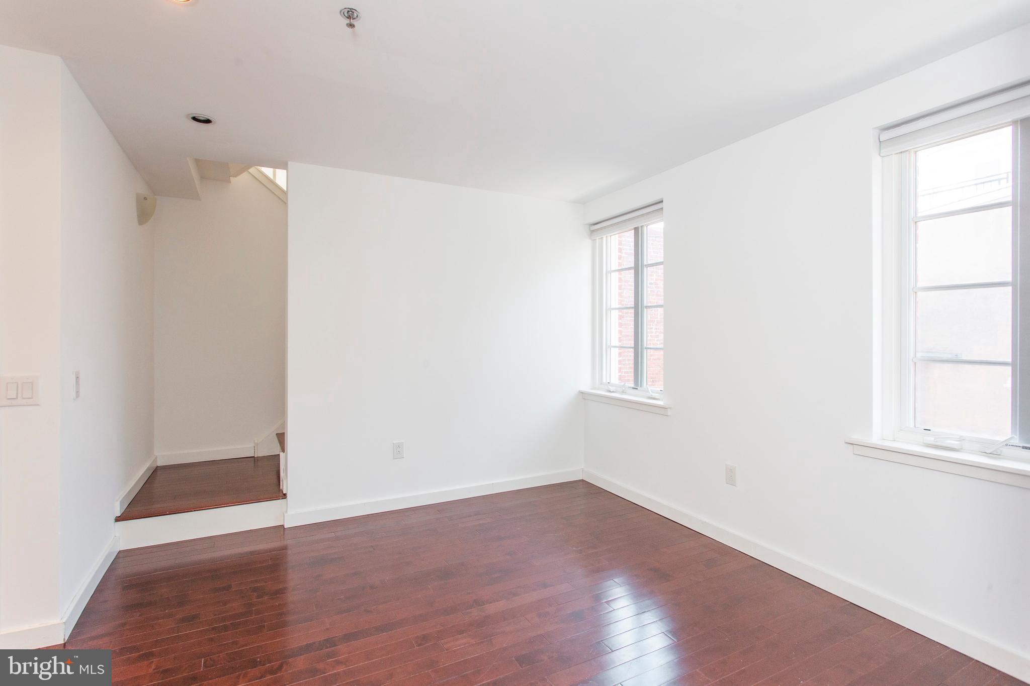 22 North Front Street, Unit PH1 Philadelphia, PA 19106 - Photo 29 of 42 an empty room with wooden floor and windows