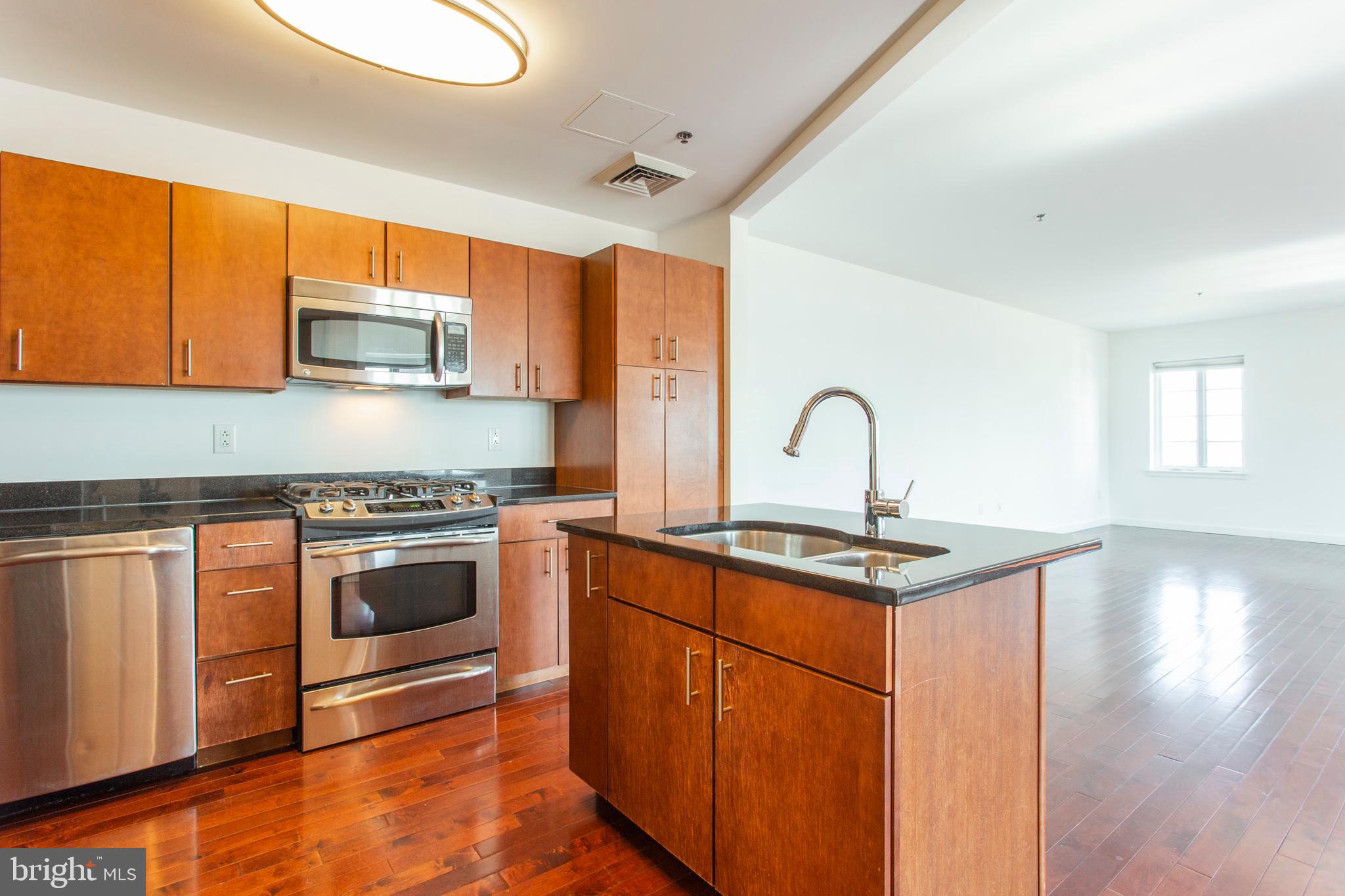22 North Front Street, Unit PH1 Philadelphia, PA 19106 - Photo 6 of 42 a kitchen with stainless steel appliances granite countertop a stove a sink and a microwave