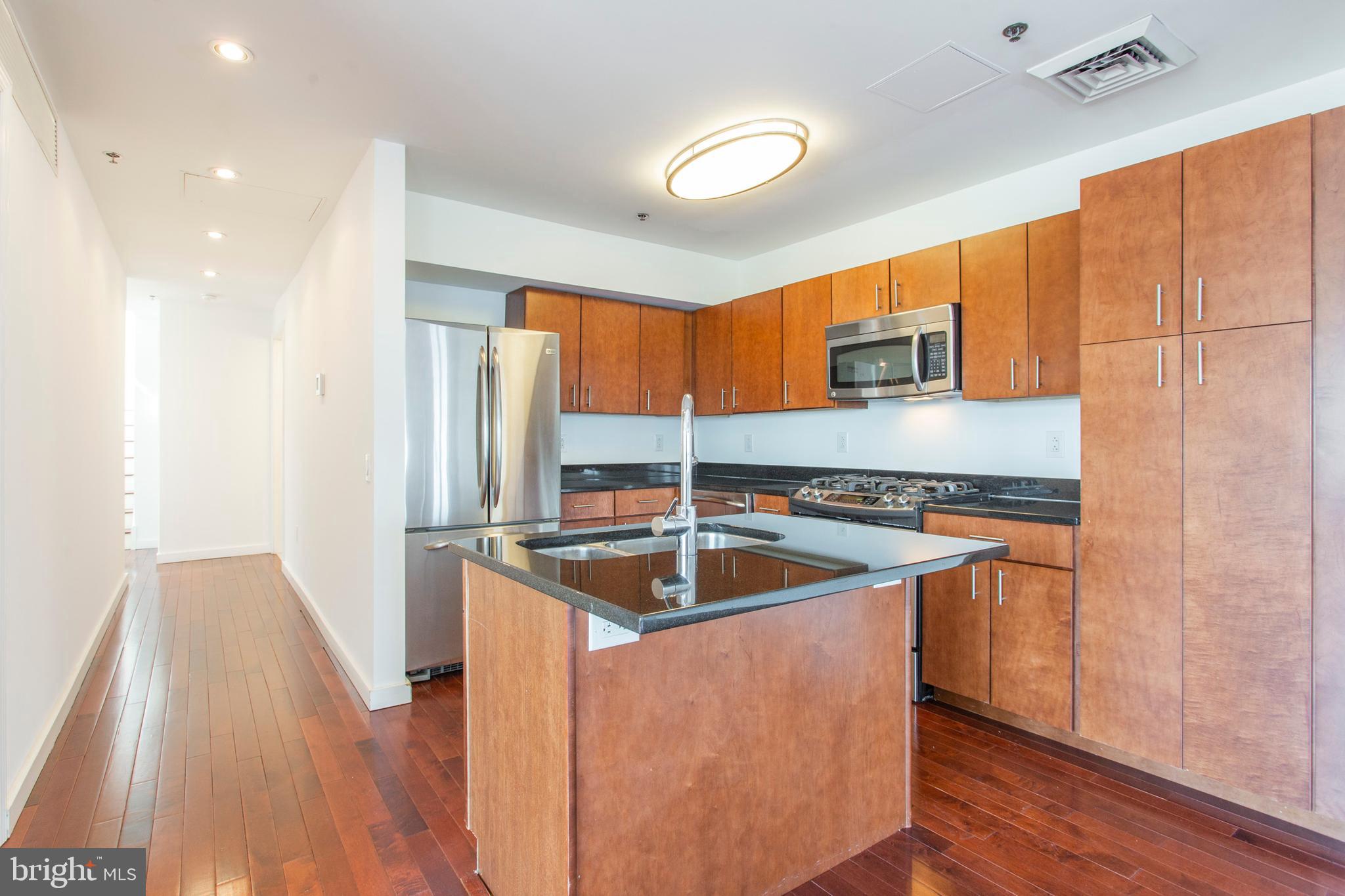 22 North Front Street, Unit PH1 Philadelphia, PA 19106 - Photo 9 of 42 a kitchen with stainless steel appliances granite countertop a sink and a refrigerator