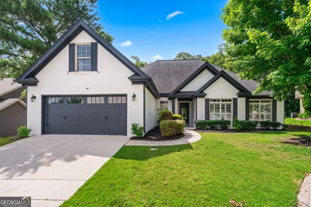 a front view of a house with a yard and garage
