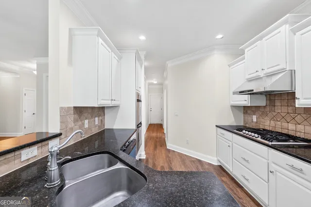 a kitchen that has a lot of cabinets in it