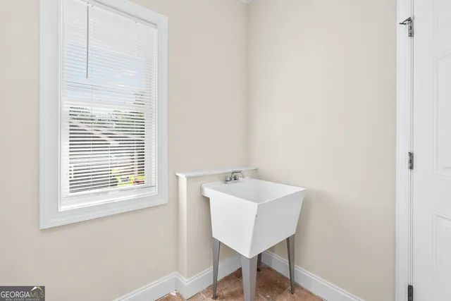 a view of a room that has a window and a table in it