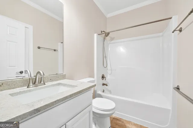 a bathroom with a sink a toilet a mirror a bathtub and shower