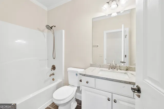 a bathroom with a sink a toilet a mirror and shower