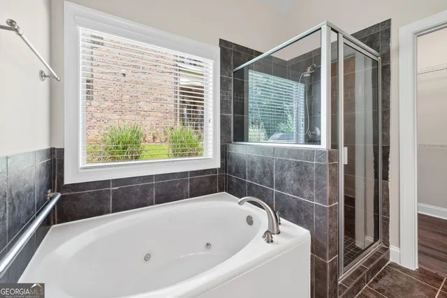 a bathroom with a bathtub and window