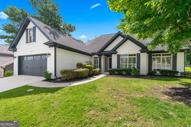 a view of a house with a patio and yard