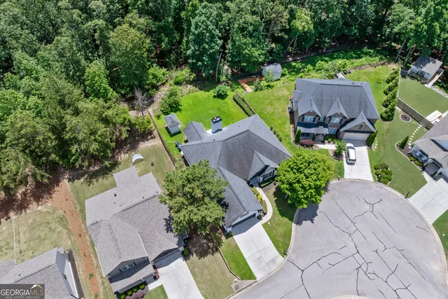 an aerial view of a house with garden space and a yard