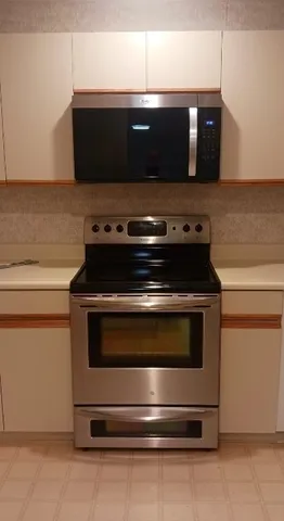 a stove top oven sitting inside of a kitchen