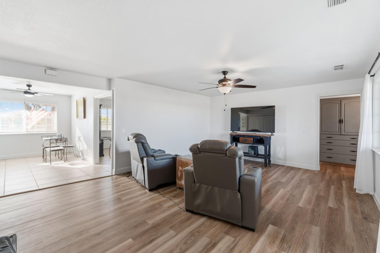 2938 North Trinity Avenue Kerman, CA 93630 - Photo 13 of 38 a living room with furniture and a chandelier