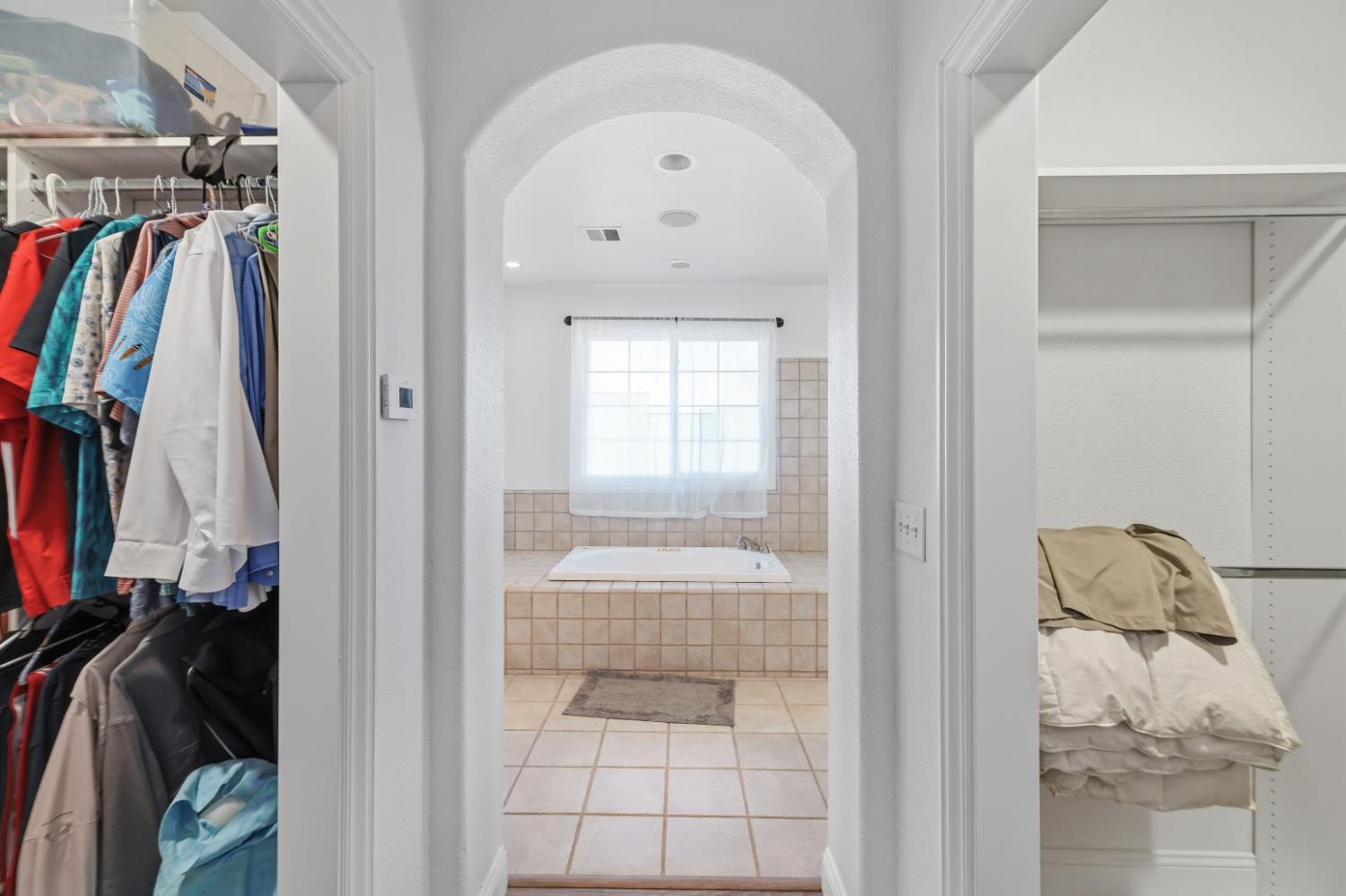 2938 North Trinity Avenue Kerman, CA 93630 - Photo 29 of 38 a view of walk in closet with clothes and shoes