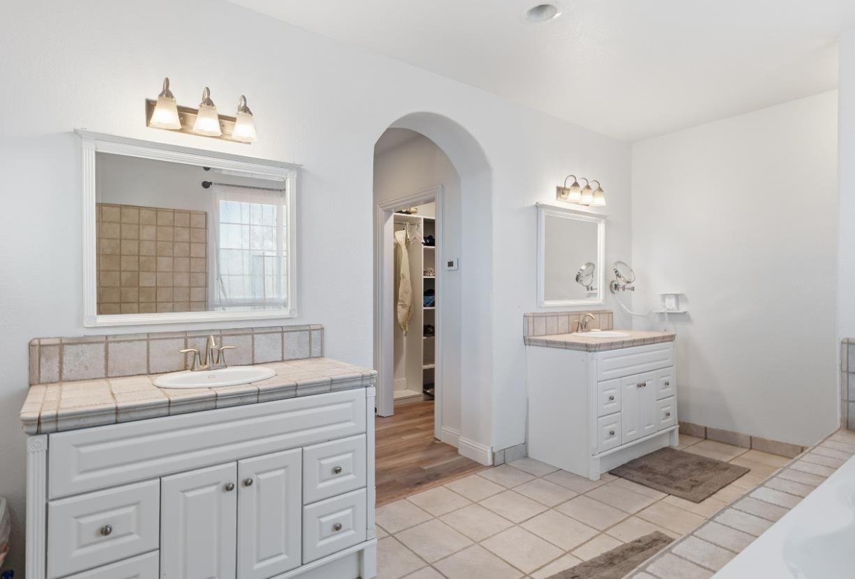 2938 North Trinity Avenue Kerman, CA 93630 - Photo 31 of 38 a bathroom with a sink and a mirror