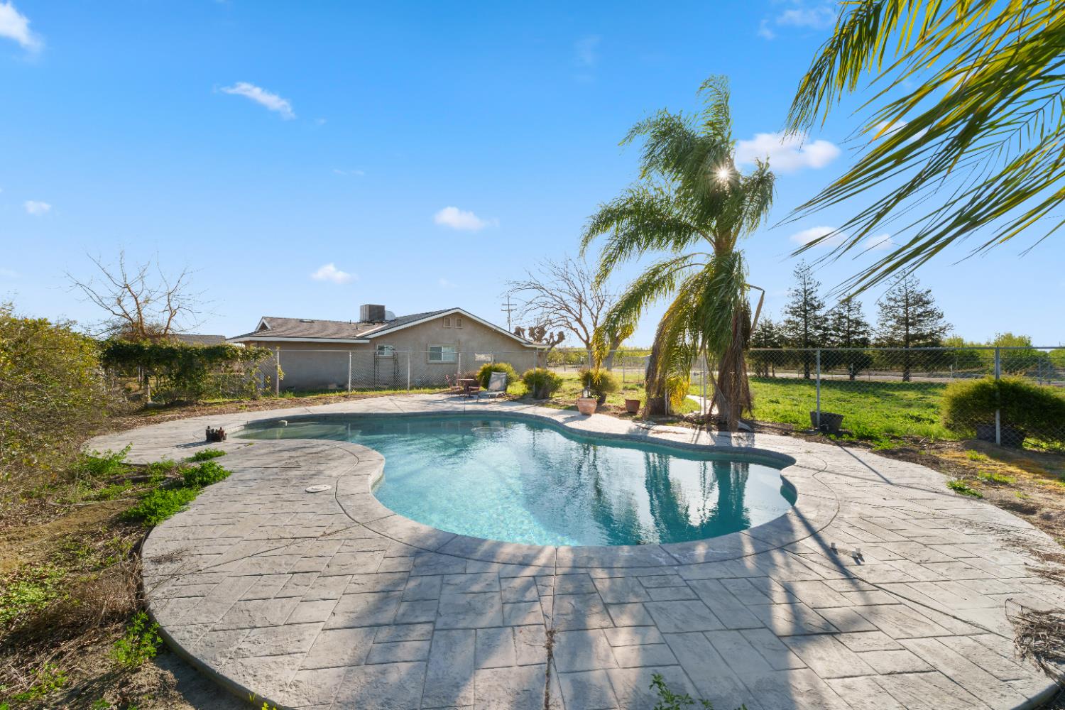2938 North Trinity Avenue Kerman, CA 93630 - Photo 36 of 38 a view of swimming pool with a patio and a yard