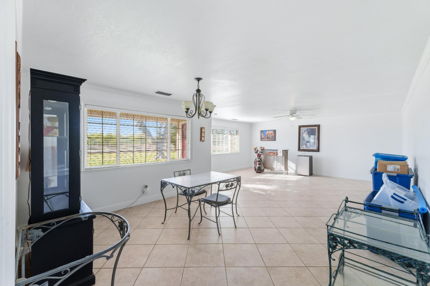 2938 North Trinity Avenue Kerman, CA 93630 - Photo 7 of 38 a living room with furniture a flat screen tv and a window