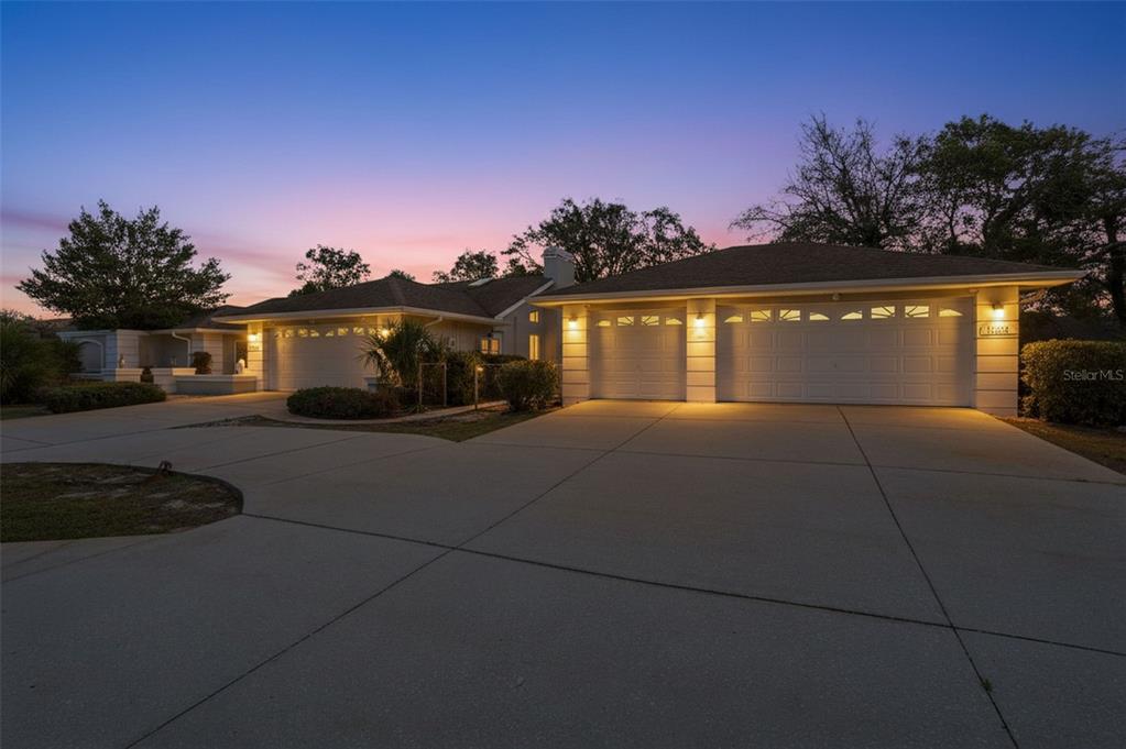 10066 Brentlawn Street Spring Hill, FL 34608 - Photo 1 of 1 a front view of a house with a yard and garage