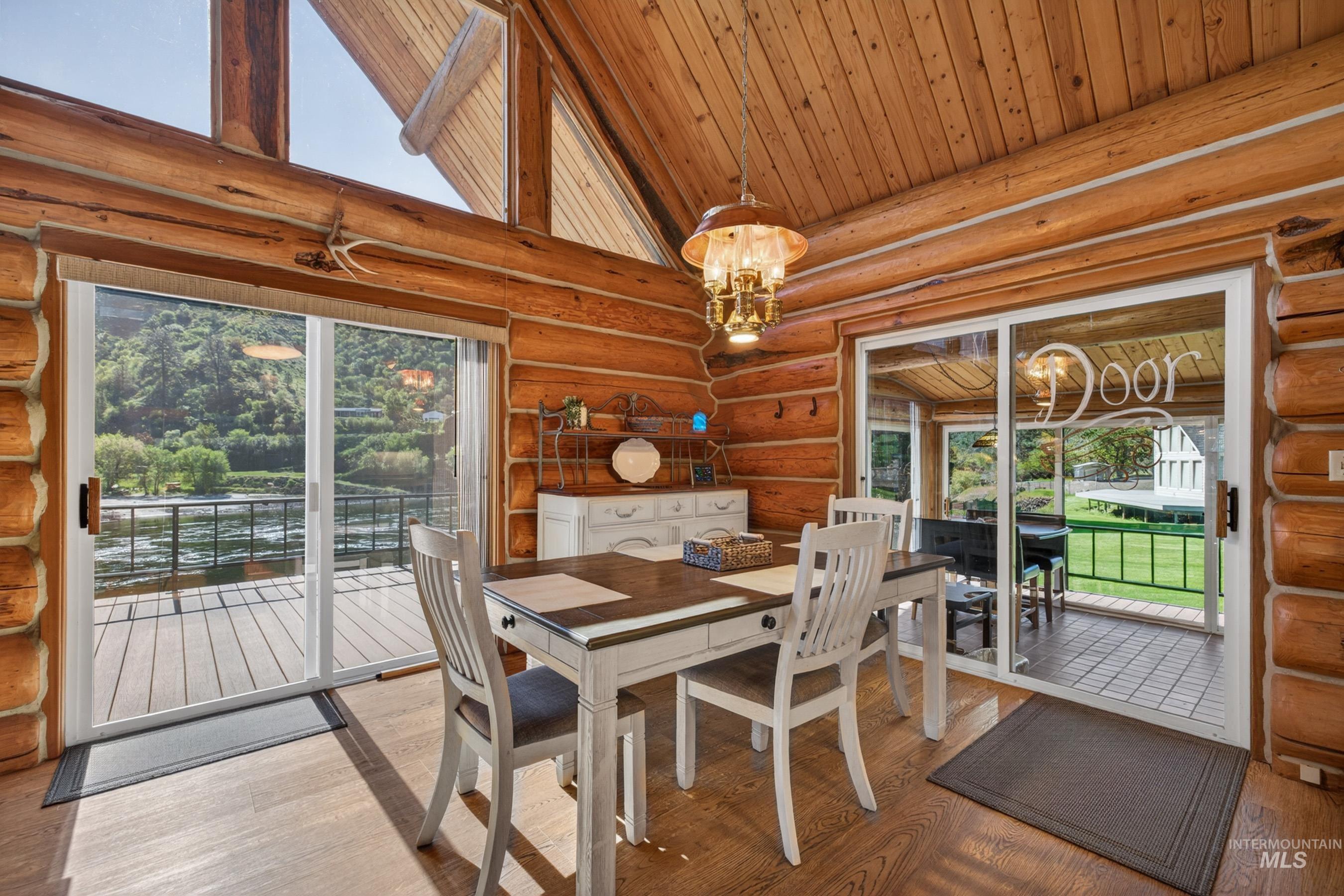 215 Doumecq Road White Bird, ID 83554 - Photo 12 of 50 Expansive wood-finish flooring with floor-to-ceiling sliding glass doors opening to an exterior deck