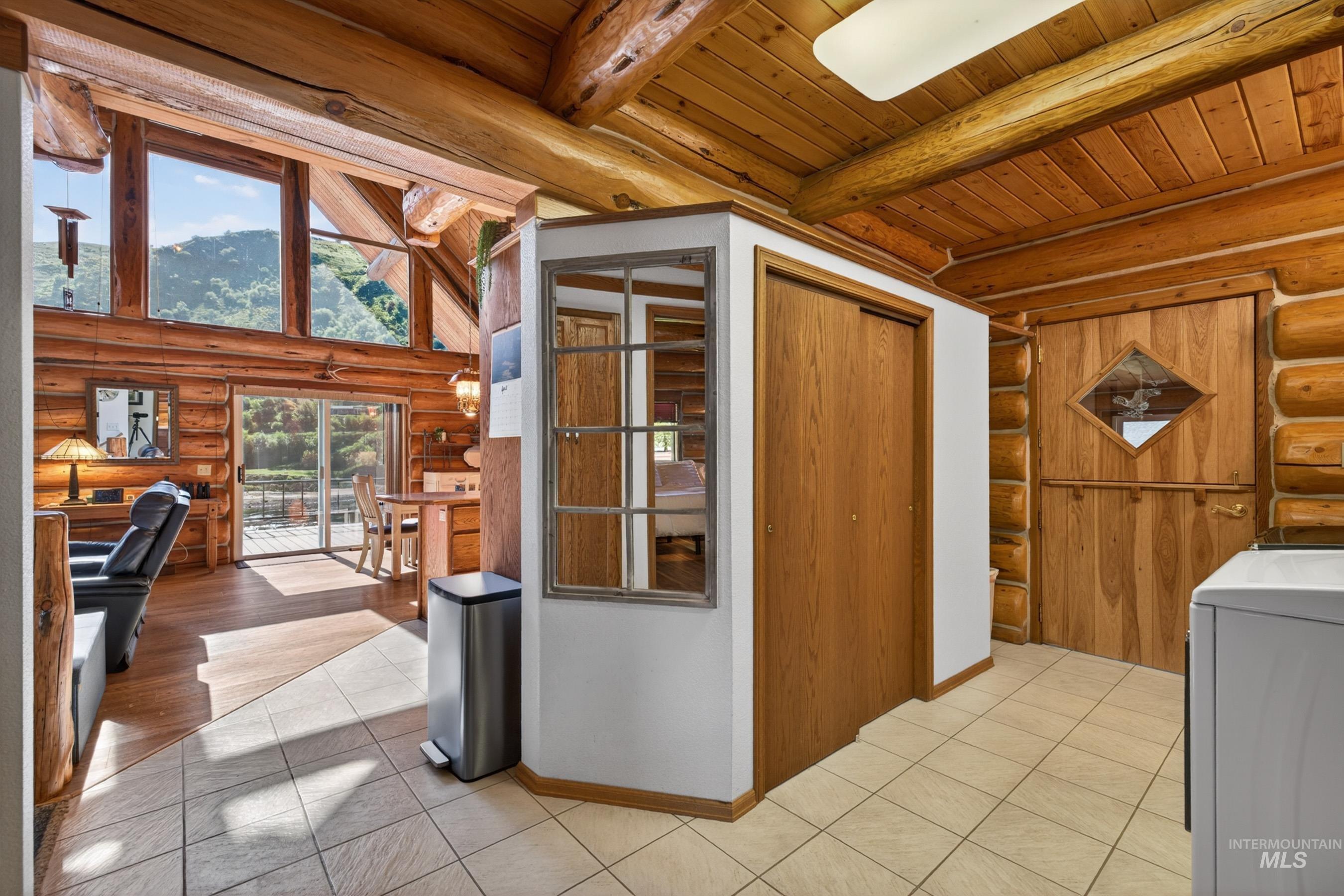215 Doumecq Road White Bird, ID 83554 - Photo 17 of 50 Vaulted ceilings with exposed log beams and a wood-finish interior