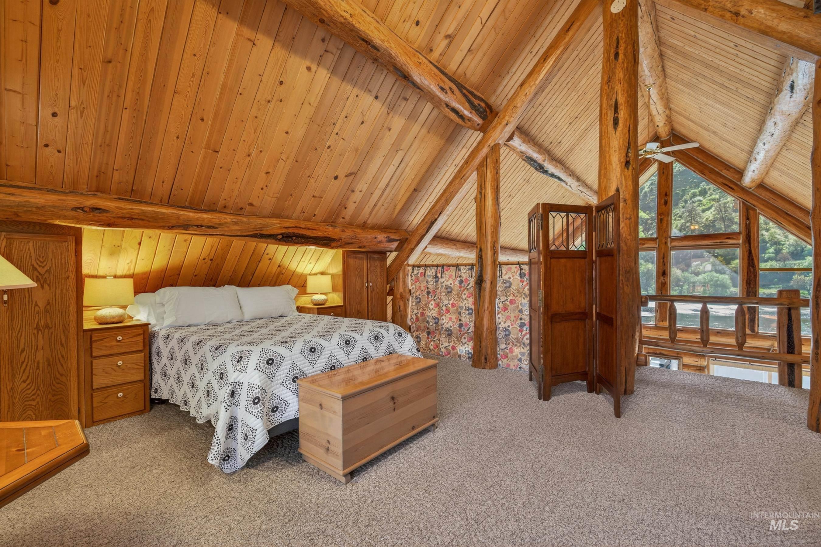 215 Doumecq Road White Bird, ID 83554 - Photo 23 of 50 Vaulted wood-paneled ceilings with exposed log beams throughout