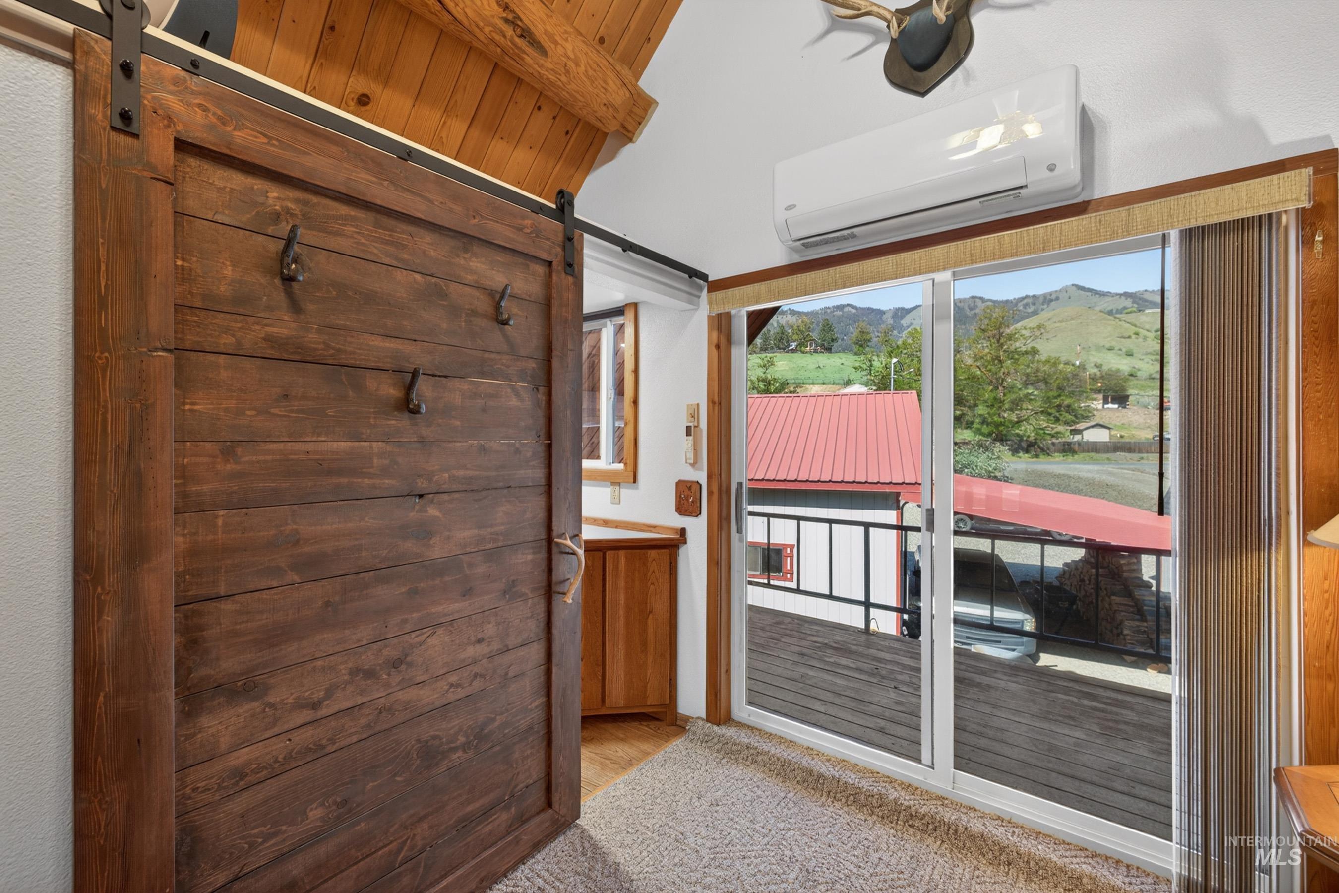 215 Doumecq Road White Bird, ID 83554 - Photo 26 of 50 Sliding barn door with dark wood finish and exposed metal track