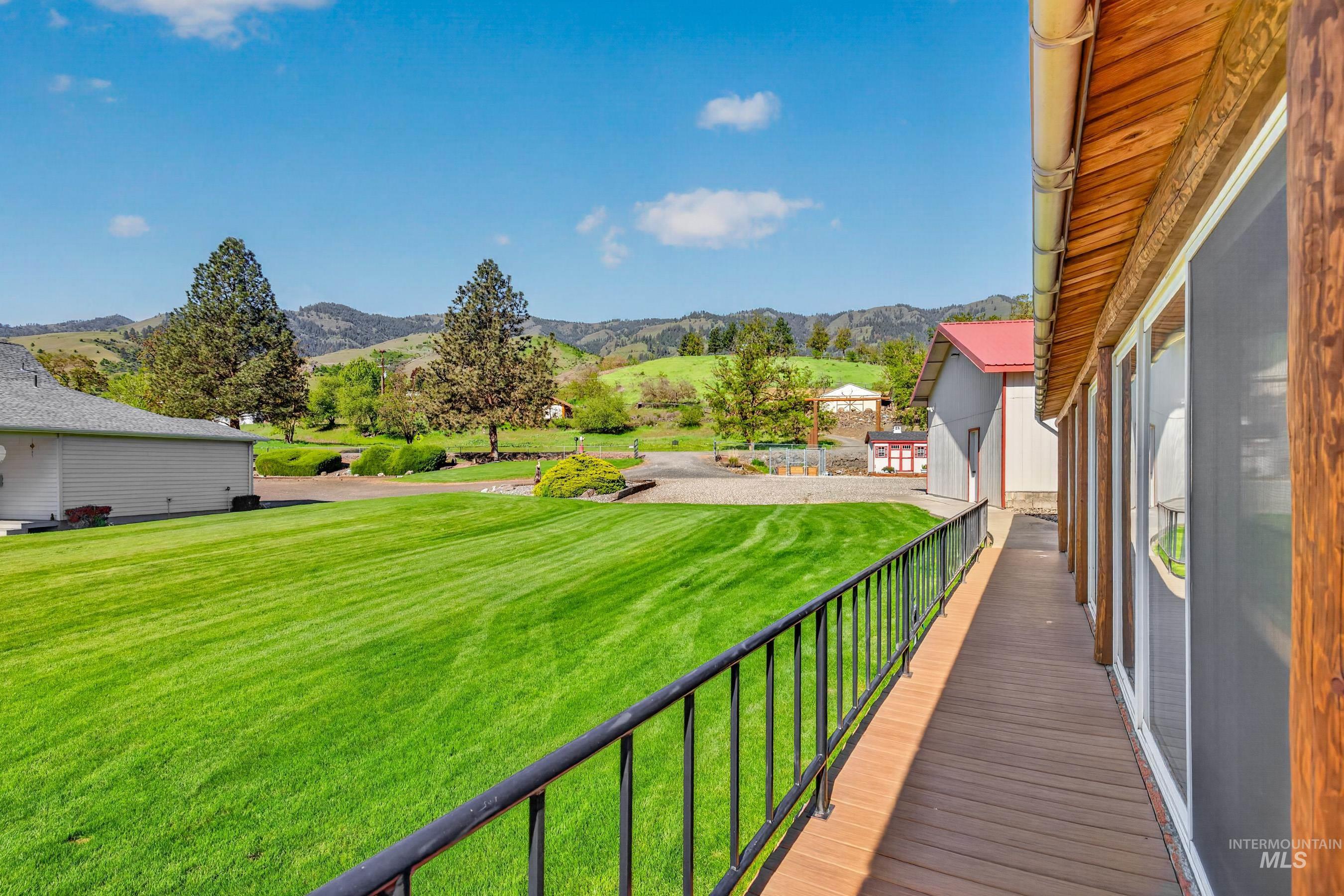 215 Doumecq Road White Bird, ID 83554 - Photo 34 of 50 Extended outdoor deck with dark railings, providing an outdoor living area