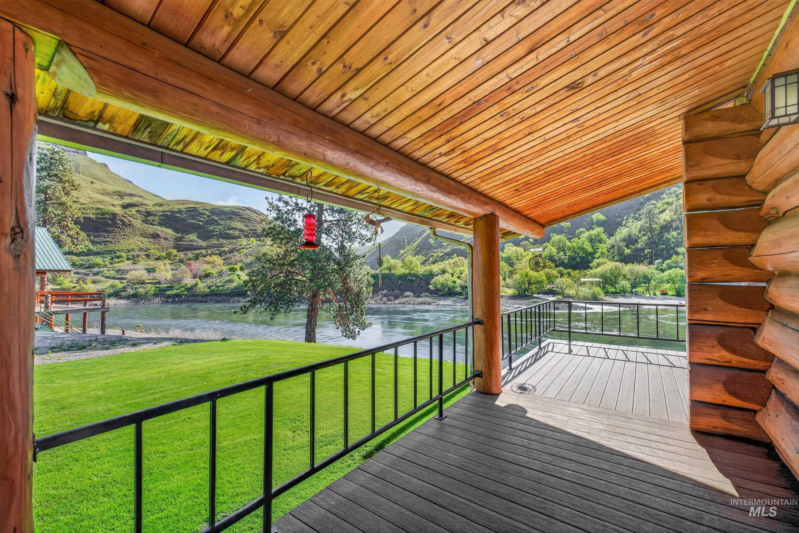 215 Doumecq Road White Bird, ID 83554 - Photo 36 of 50 Covered patio with a composite deck and log beam construction