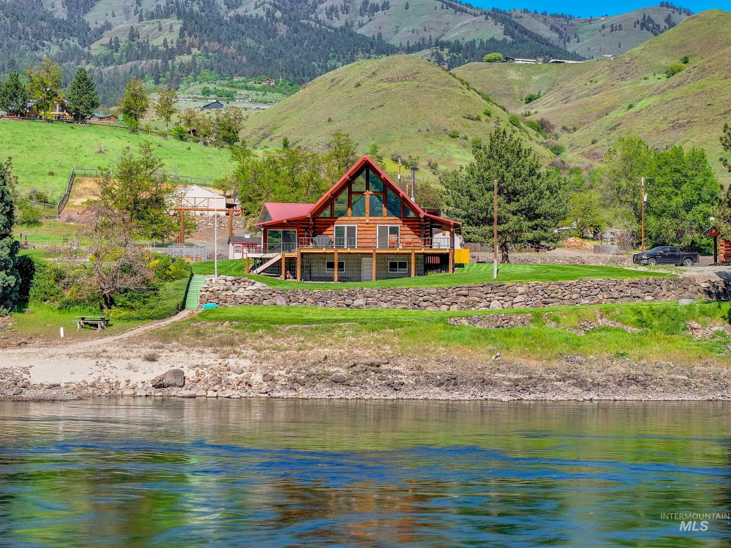 215 Doumecq Road White Bird, ID 83554 - Photo 46 of 50 Log home featuring a red metal roof, A-frame design, and multi-level decking
