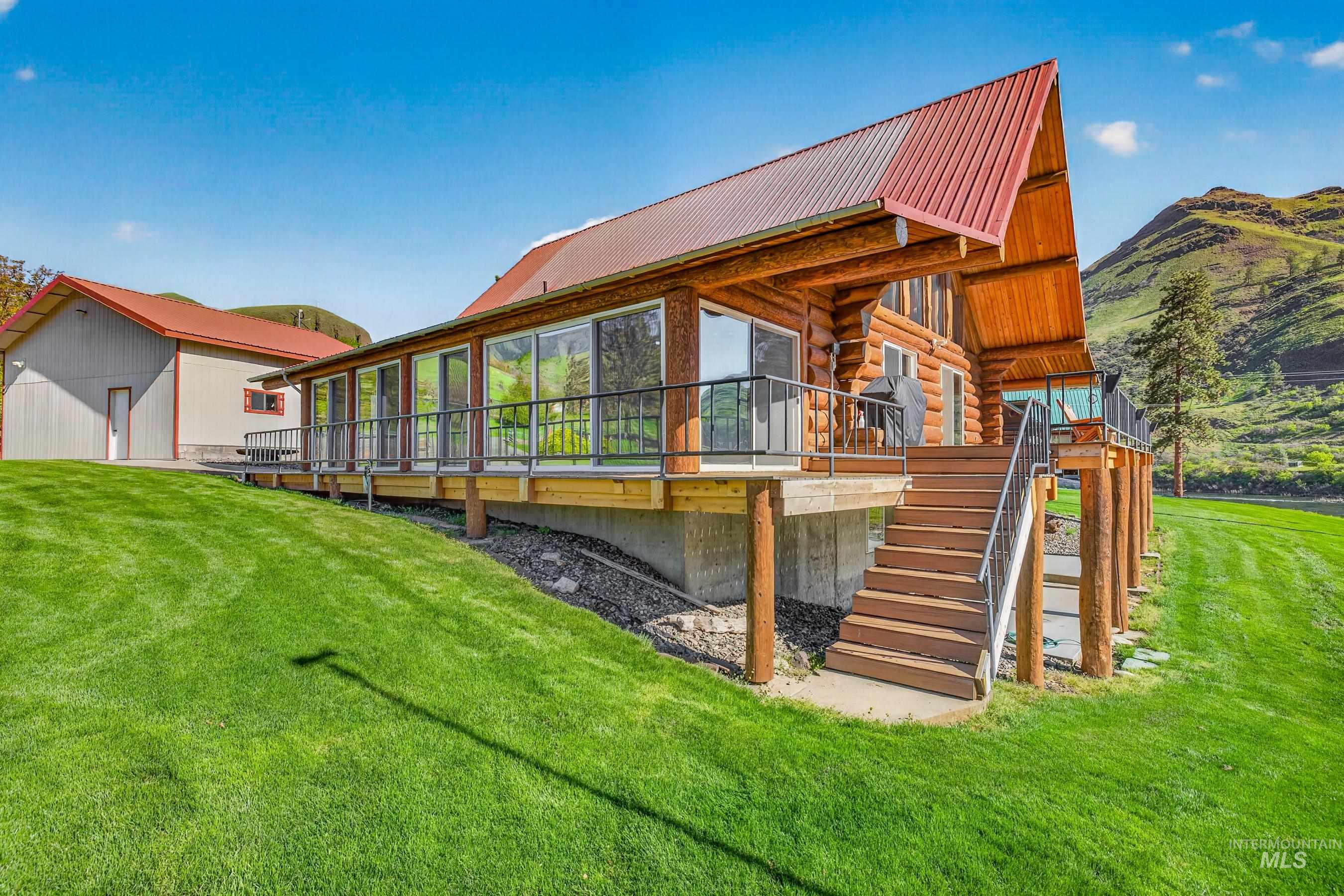 215 Doumecq Road White Bird, ID 83554 - Photo 5 of 50 Log cabin-style residence featuring a prominent red metal roof