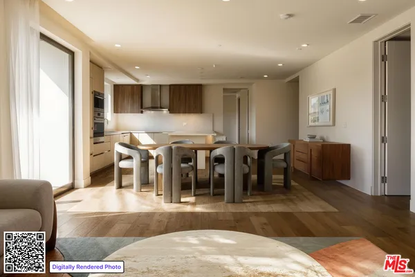 a living room with lots of furniture and a view of kitchen