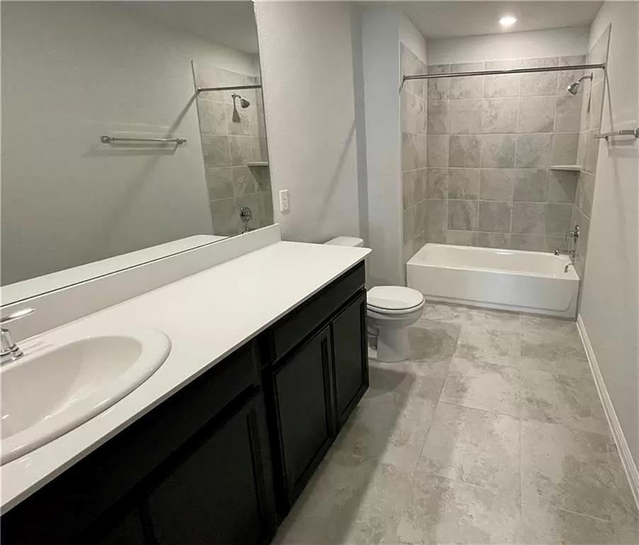 317 Serpens Street Georgetown, TX 78628 - Photo 7 of 13 a bathroom with a double vanity sink toilet and shower