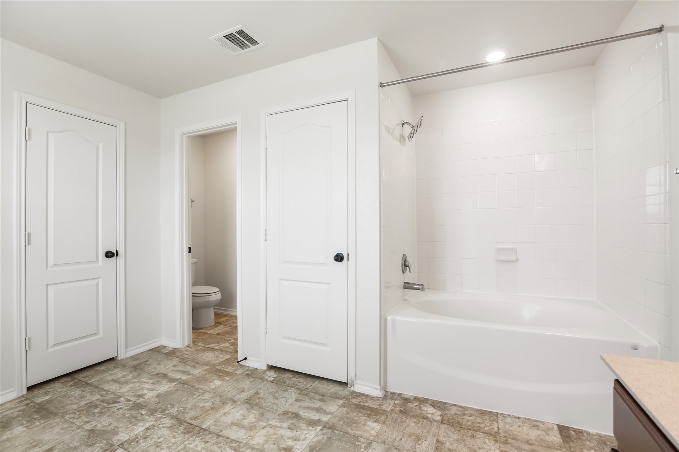 18917 Rushmore Street Manor, TX 78653 - Photo 18 of 28 a bathroom with a bathtub and a shower