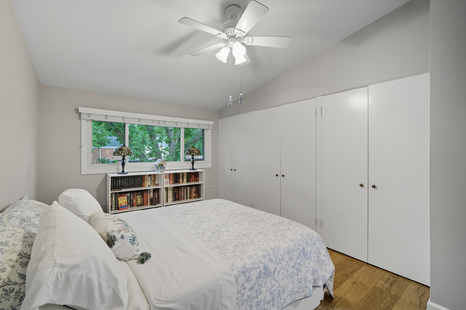 645 Spring Road Glenview, IL 60025 - Photo 25 of 31 a bedroom with a bed next to a window and a chandelier