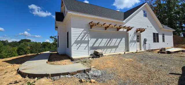 a backyard of a house with fire pit and outdoor seating