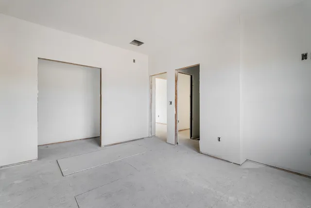 an empty room with closet area