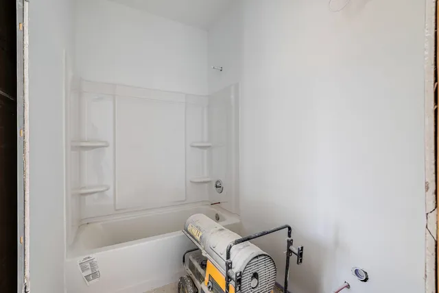 a bathroom with a bathtub and shower