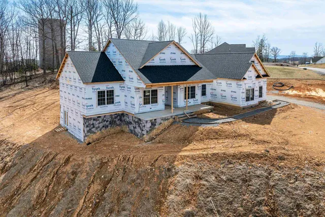 a view of a house with wooden fence