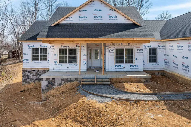 a view of a house with backyard and sitting area