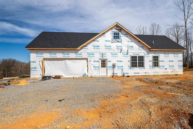 a front view of a house with a road