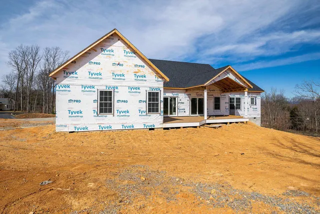 a view of a white house with a yard