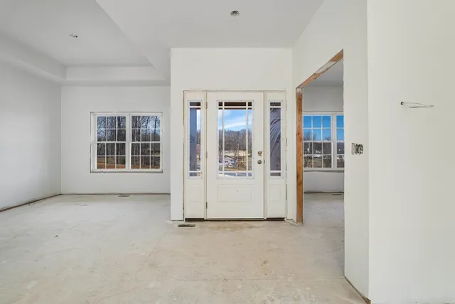 an empty room with windows and closet