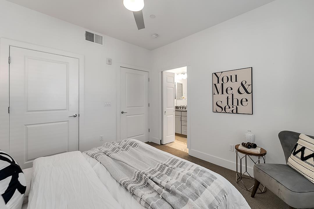 1421 Nightshade Road, Unit 30 Milpitas, CA 95035 - Photo 12 of 28 a bedroom with a bed and a painting on the wall