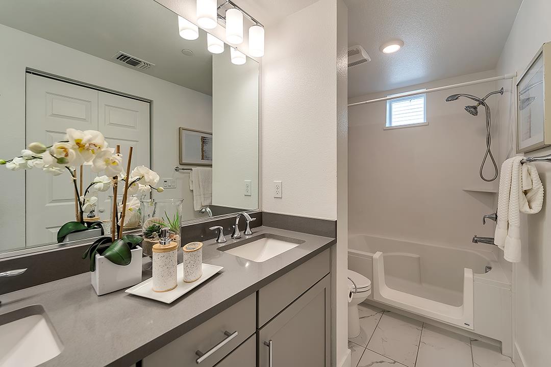 1421 Nightshade Road, Unit 30 Milpitas, CA 95035 - Photo 14 of 28 a bathroom with a sink a vanity and a mirror