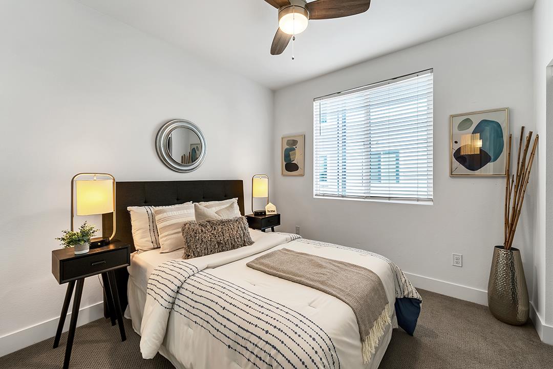 1421 Nightshade Road, Unit 30 Milpitas, CA 95035 - Photo 18 of 28 a bedroom with a bed and a chandelier