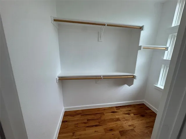 a bathroom with a granite countertop sink a toilet a mirror and vanity
